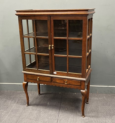Lot 464 - An Edwardian oak glazed cabinet on associated...