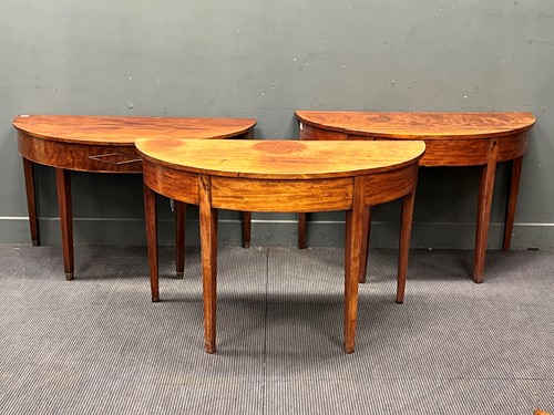 Lot 586 - Three George III and later mahogany demi lune...