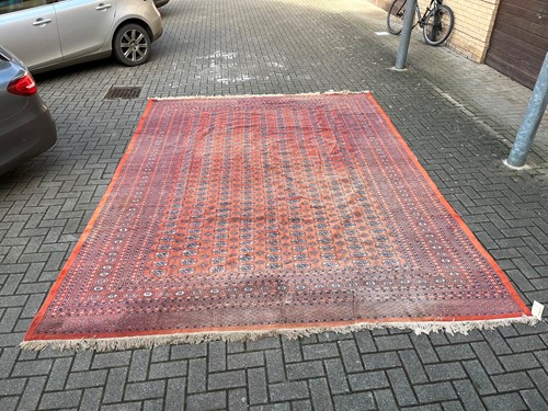 Lot 714 - A faded Bokhara rug in red and blue (AF)....