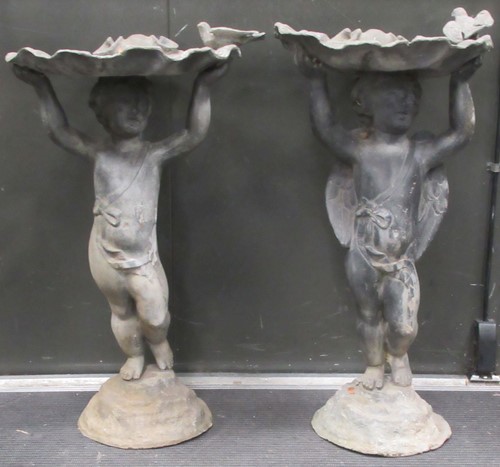 Lot 692 - Two similar lead bird baths on Putti supports,...