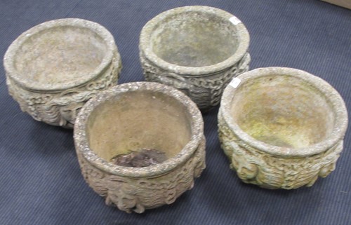 Lot 699 - A set of four composite stone planters...