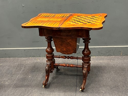 Lot 669 - A Victorian walnut fold over games table 72 x...