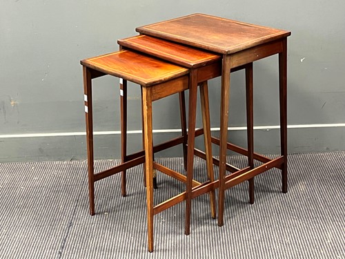 Lot 543 - A nest of three mahogany tables with satinwood...