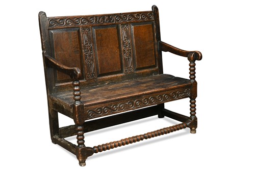 Lot 459 - A small carved oak panel back settle, late 17th century