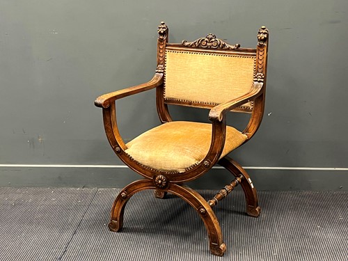 Lot 525 - A Continental walnut Savonarola chair in the...