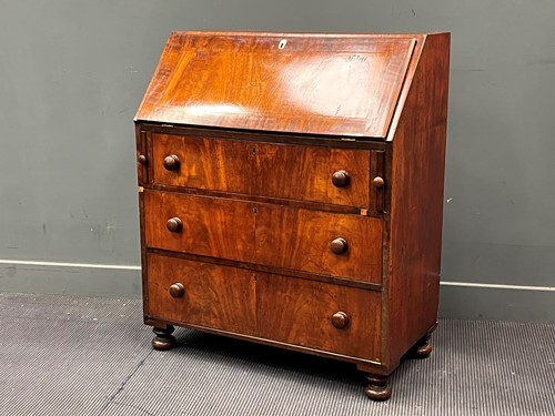 Lot 475 - A 19th century mahogany bureau the fall front...