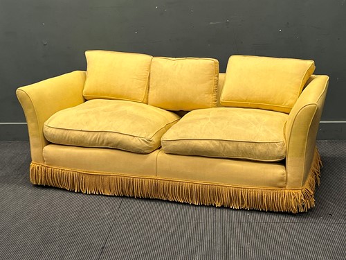 Lot 484 - A yellow sofa with fringe