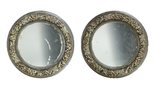 Lot 772 - A pair of circular floral decorated gesso mirrors