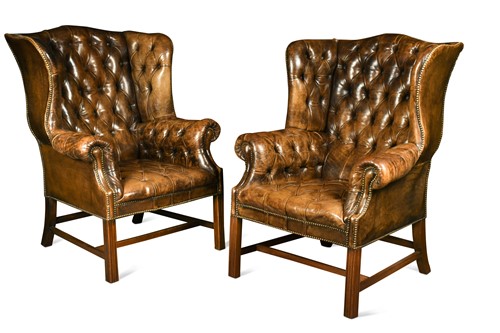 Lot 615 - A pair of George III style leather wingback armchairs