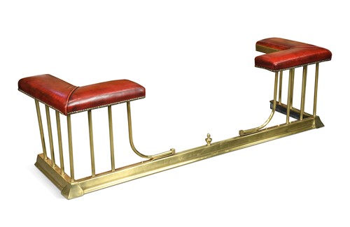 Lot 613 - A brass club fender, modern