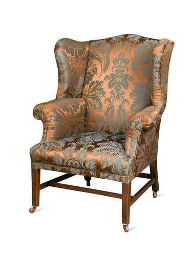 Lot 555 - A George III style mahogany wingback armchair