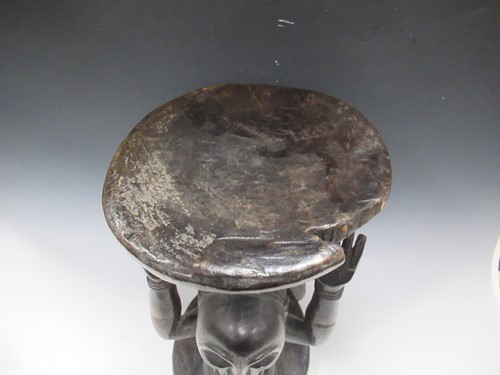 Lot 32 - A Luba Hemba carved stool, the circular top...