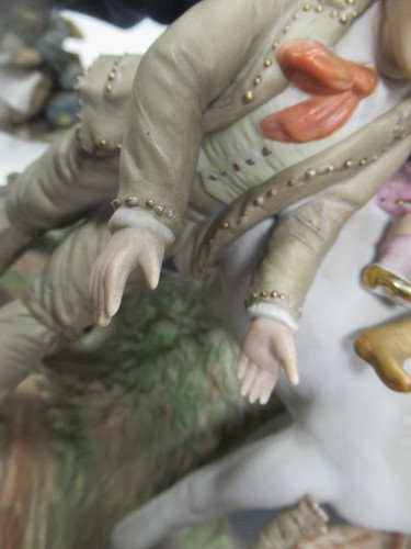 Lot 6 - A painted bisque family with horse figure...