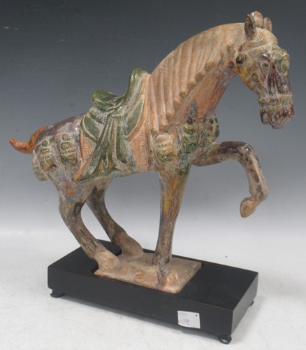 Lot 61 - A Tang style pottery model of a horse, on a...
