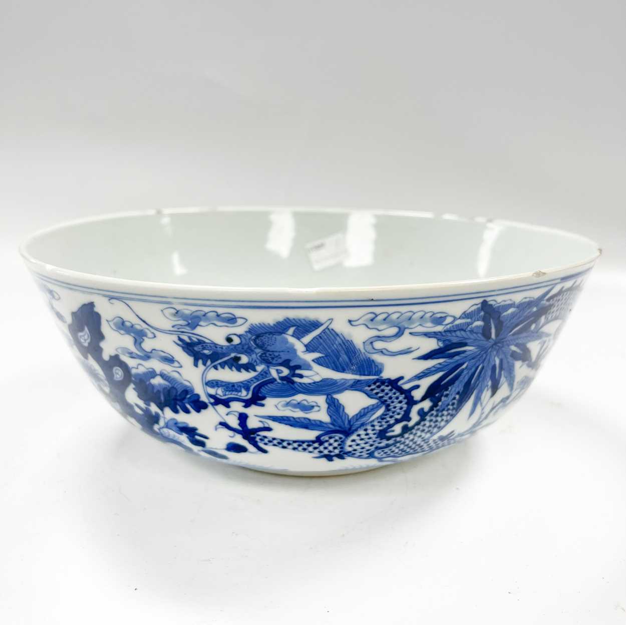 Lot 36 - A Chinese blue and white porcelain dragon bowl, Qing Dynasty, 19th century