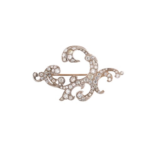 Lot 182 - A diamond set scroll brooch