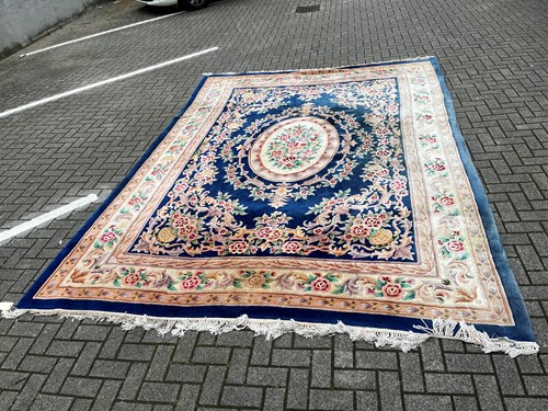 Lot 700 - A machine woven blue ground floral decorated...