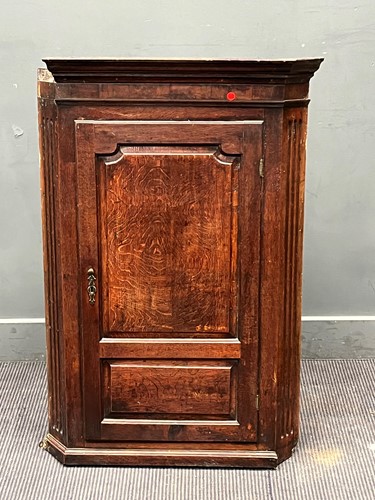 Lot 782 - An 18th century oak corner cupboard, the...