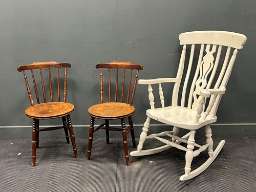 Lot 557 - A white painted pine stick back rocking chair...