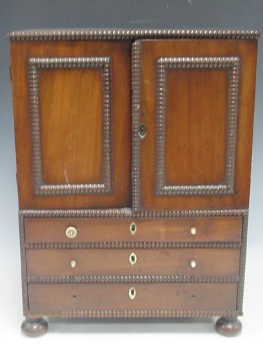 Lot 296 - A miniature Regency mahogany wardrobe, with...
