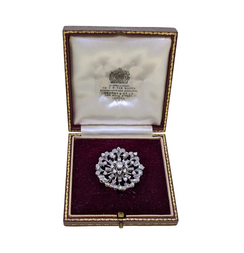 Lot 151 - A diamond set floral brooch