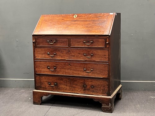Lot 329 - A George III mahogany bureau, the fall front...