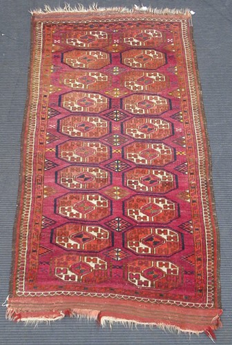 Lot 508 - A red ground Bokara rug, together with smaller...