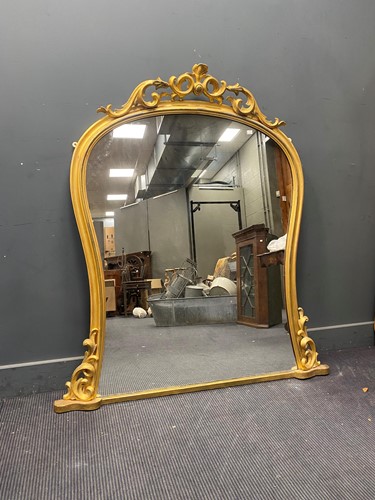 Lot 386 - A Victorian gilt overmantel mirror, of arched...