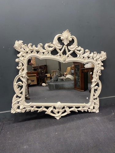 Lot 811 - A Rococo style white painted wall mirror, the...