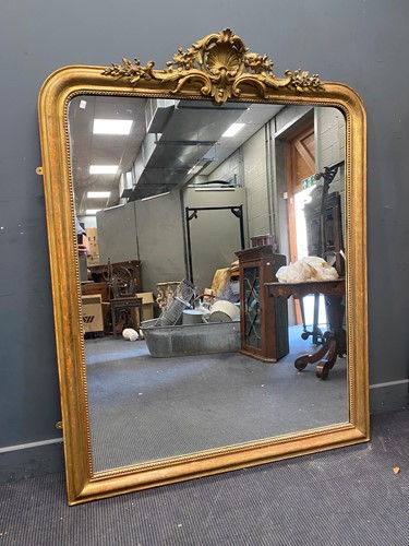 Lot 388 - A Victorian gilt overmantel mirror the moulded...