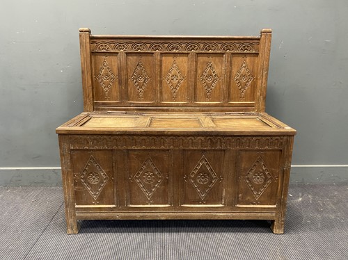 Lot 297 - An oak panelled hall bench with lozenge carved...