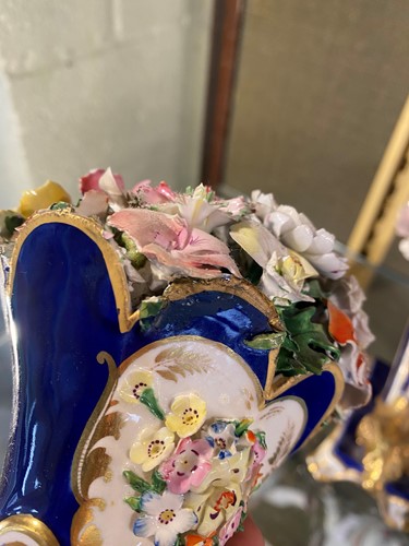 Lot 1 - A pair of Davenport blue and gilt rams head...