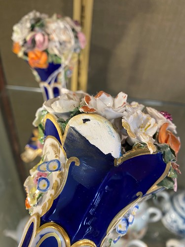 Lot 1 - A pair of Davenport blue and gilt rams head...