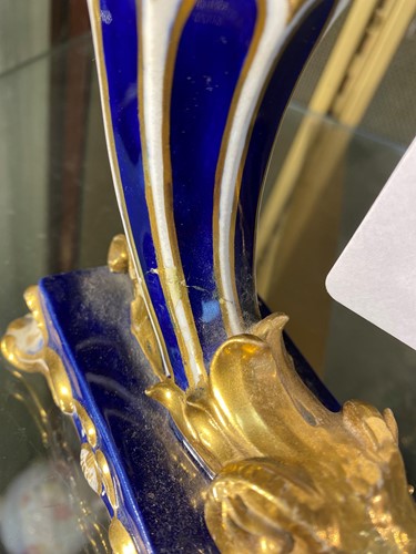 Lot 1 - A pair of Davenport blue and gilt rams head...