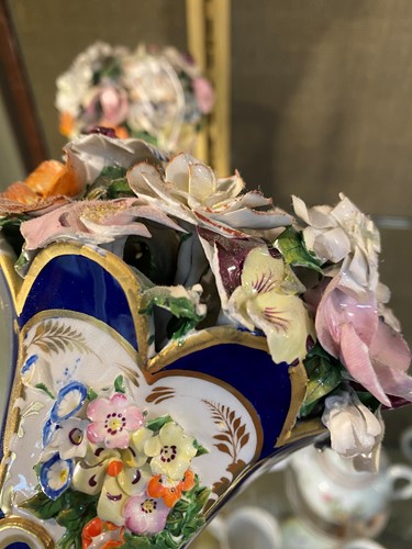Lot 1 - A pair of Davenport blue and gilt rams head...