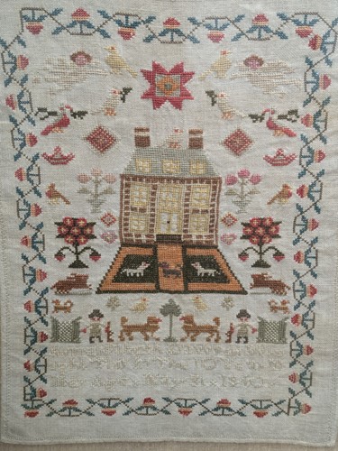 Lot 314 - A 19th century sampler - a house decorated...