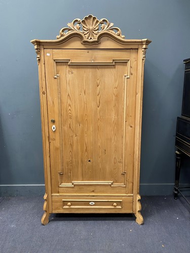 Lot 345 - A French style pine cupboard, the pediment...