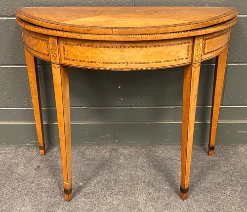 Lot 769 - A George III satinwood demi lune card table,...