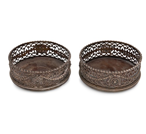 Lot 295 - A George III 18th century silver bottle coaster together with a later example