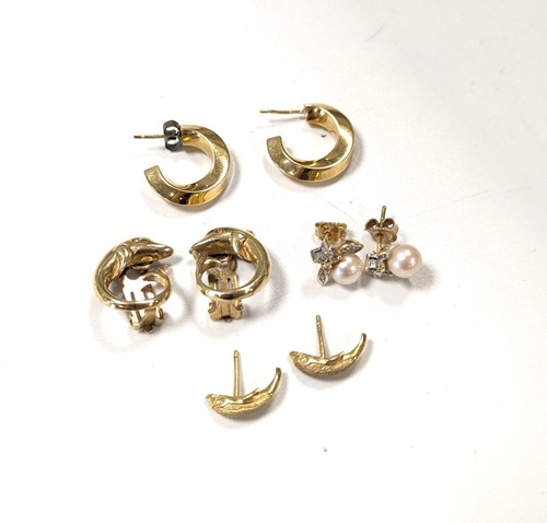 Lot 416 - A pair of dolphin earrings stramped '585'...