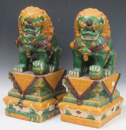 Lot 51 - A pair of green and yellow glazed Chinese Fu...