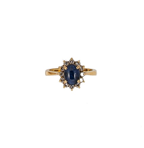 Lot 51 - A cabochon sapphire and diamond cluster ring