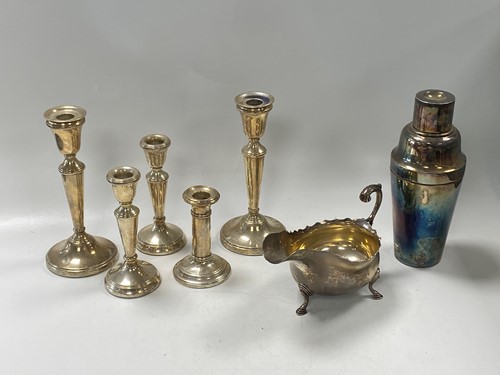 Lot 377 - Two pairs of silver candlesticks along with a...