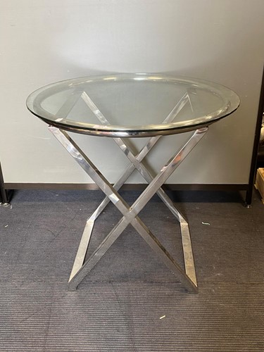 Lot 654 - A modern circular glass topped table on a...