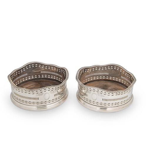Lot 342 - A pair of Edward VIII silver bottle coasters
