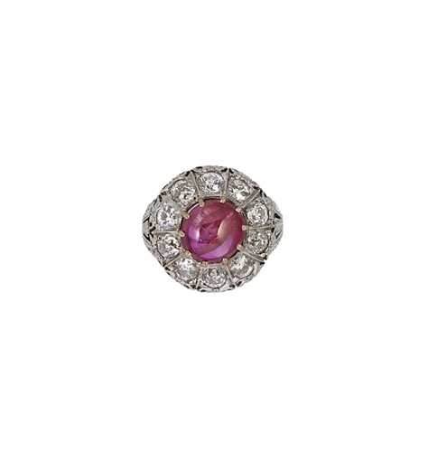 Lot 167 - A cabochon ruby and diamond cluster ring