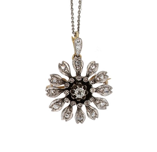 Lot 127 - A diamond set flower pendant/brooch