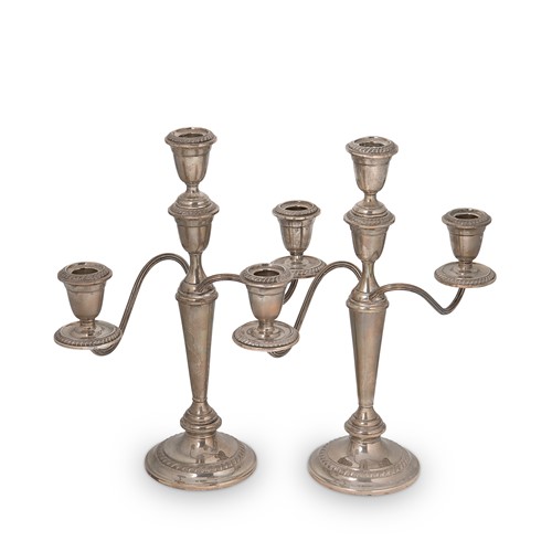 Lot 270 - A pair of 20th century American metalwares silver metamorphic three light candelabra