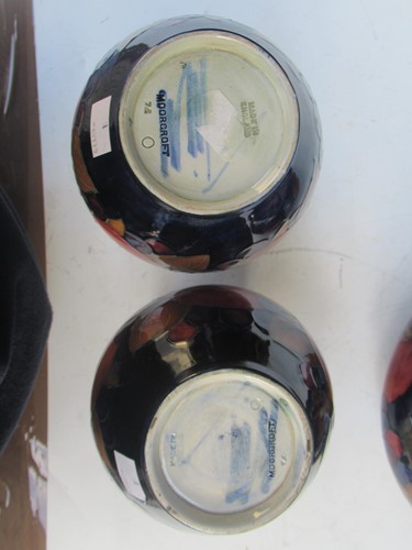 Lot 29 - A pair of Moorcroft Pomegranate pattern vases...