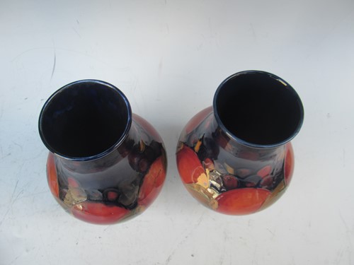 Lot 29 - A pair of Moorcroft Pomegranate pattern vases...